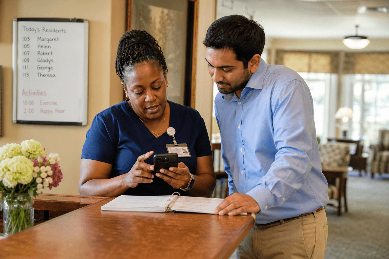 Senior living staff reviewing updates together at a nursing station
